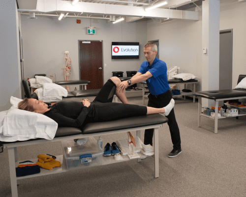 A man doing physiotherapy to a women