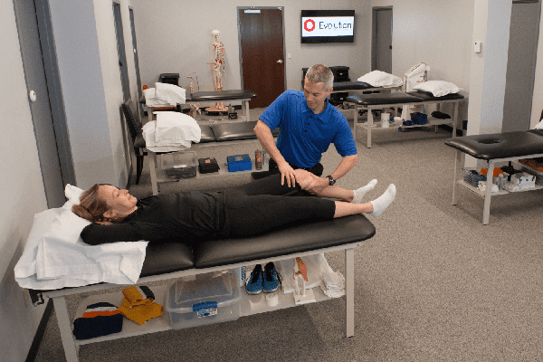 The man appears to be a massage therapist, providing a professional massage to the woman