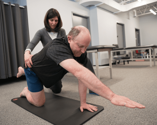 The man appears to be stretching or practicing yoga